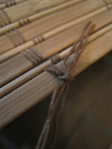 Tie a knot at the top of the shade