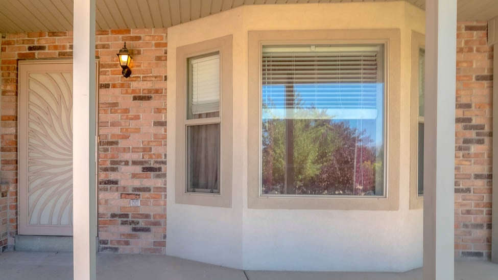 Exterior porch with blinds in bay windows