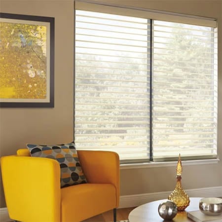 Sheer shades in sitting room with vanes open