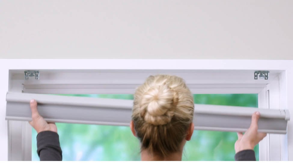 Woman Removing Window Treatment