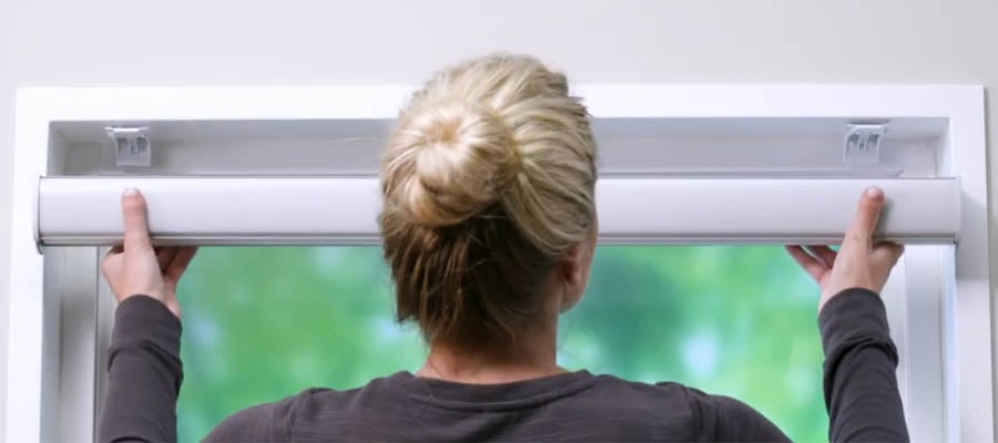 Woman installing a custom blind